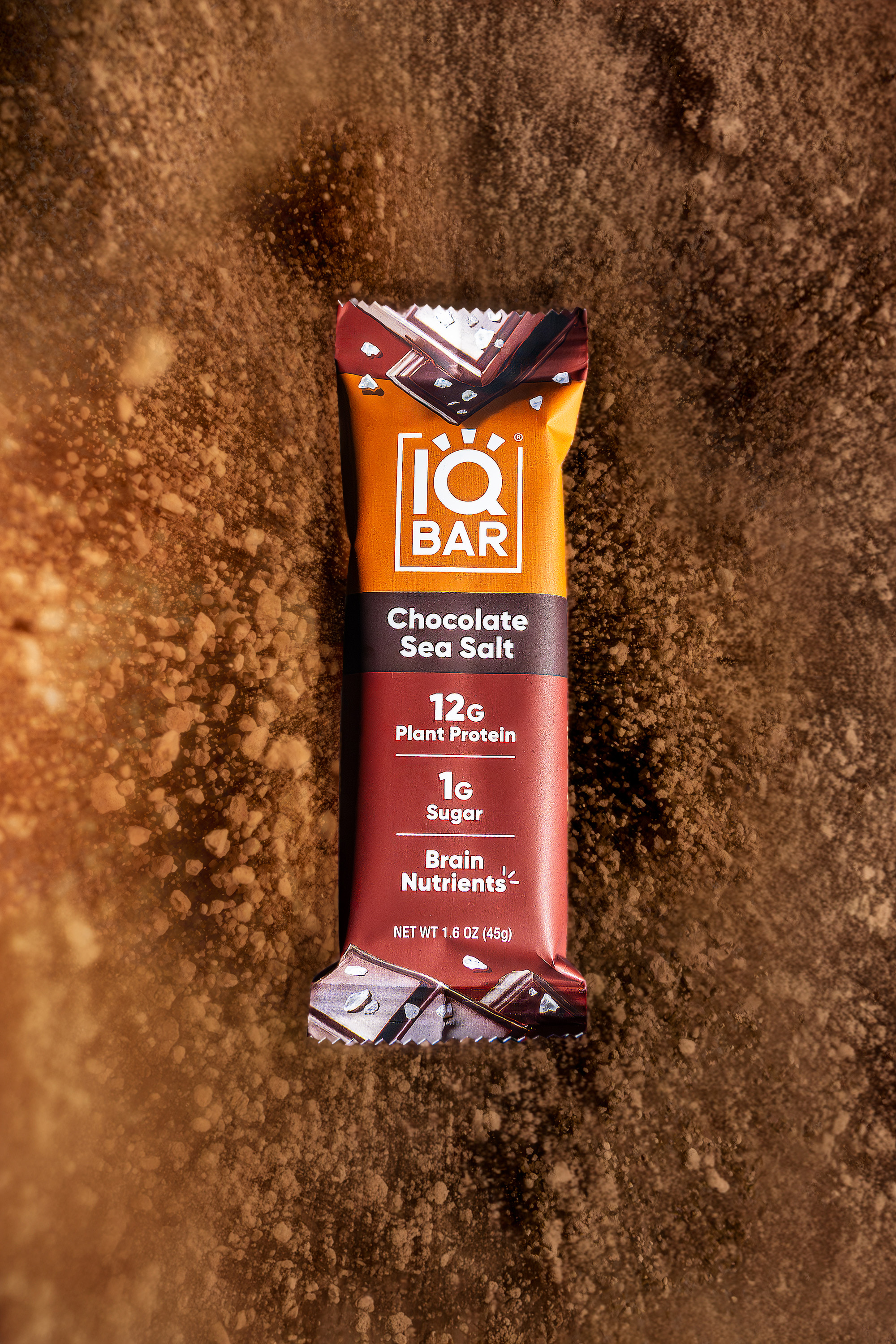 IQBAR Chocolate Sea Salt bar on cocoa powder with dust in motion, food photography, Photos by Lars.