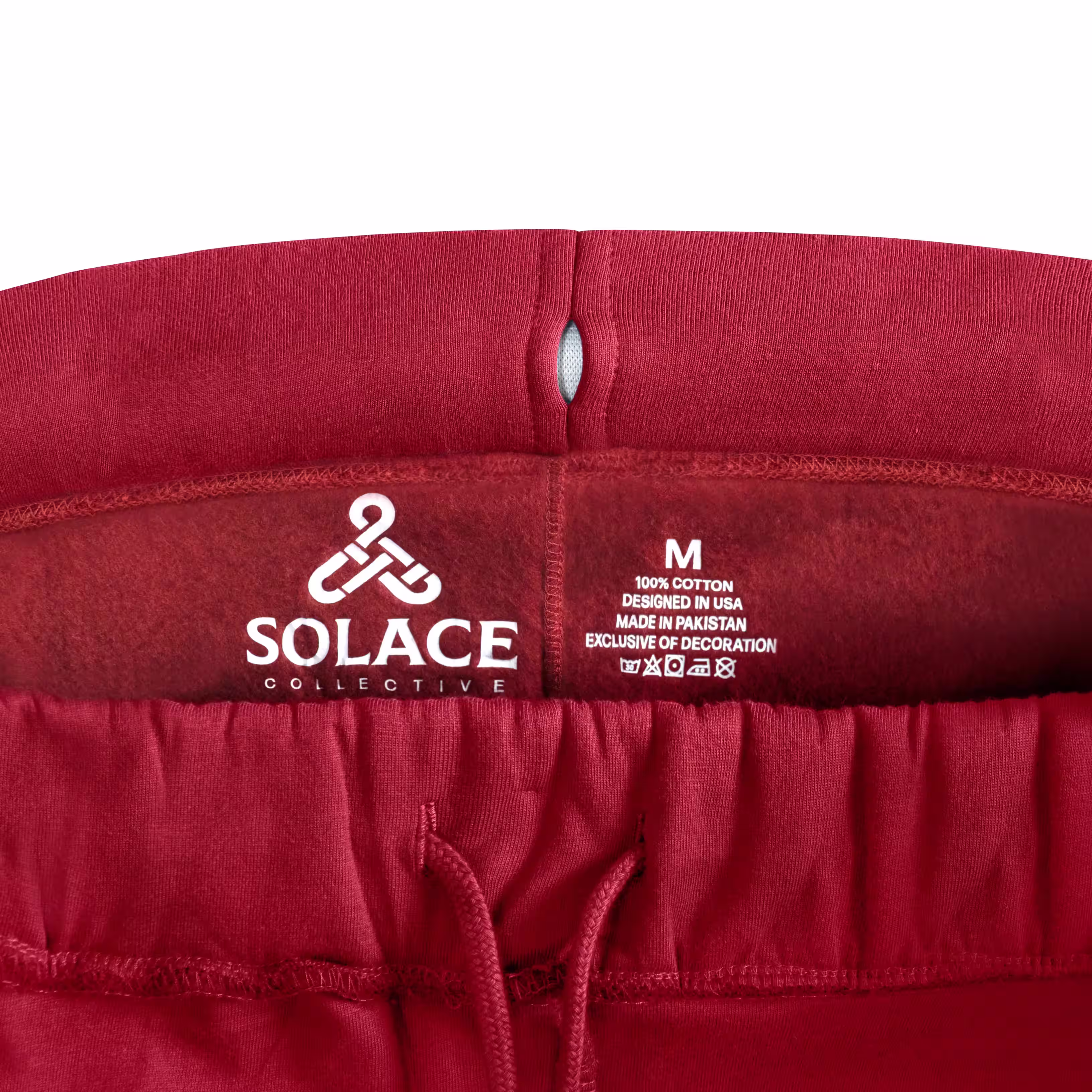 Red SOLACE sweatpants waistband detail photograph with red stitching, apparel product photography by Photos by Lars.