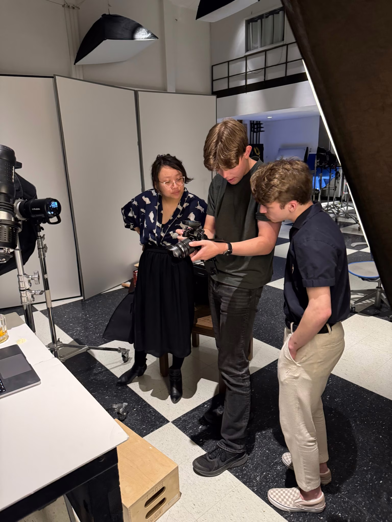 Photographer and team reviewing product images on camera during a behind-the-scenes studio shoot at Photos by Lars