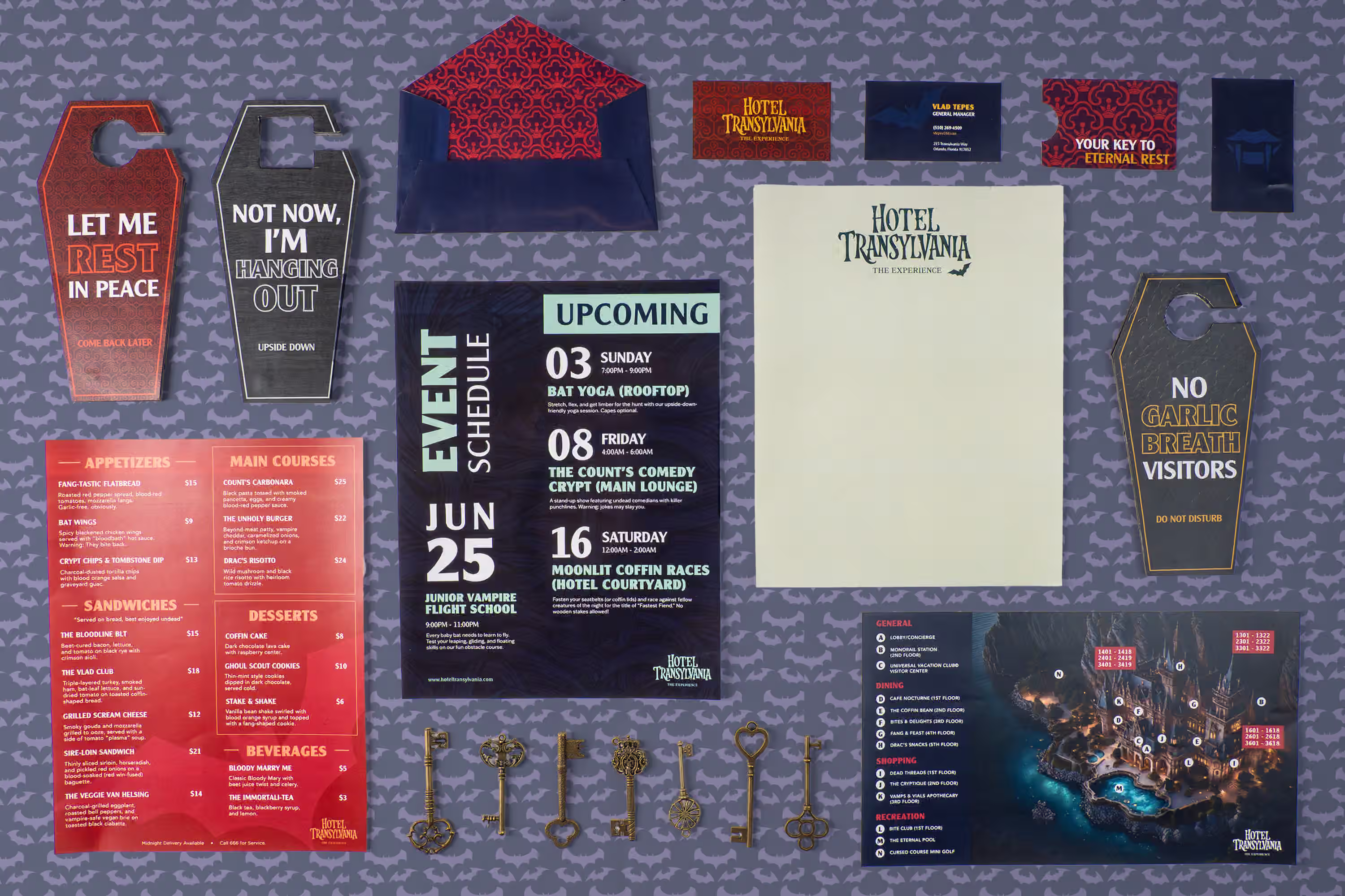 Overhead flat lay of Hotel Transylvania Experience brand collateral including menus, event schedules, door hangers, and business cards