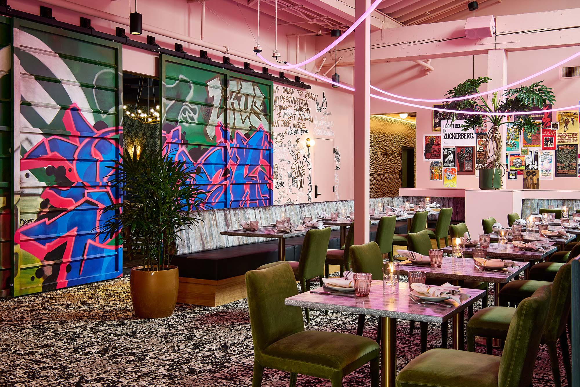 The Malarkey restaurant interior in Portland, designed by Tricorn Black, featuring the Graffiti Room with custom mural doors, eclectic artwork and layered dining furnishings