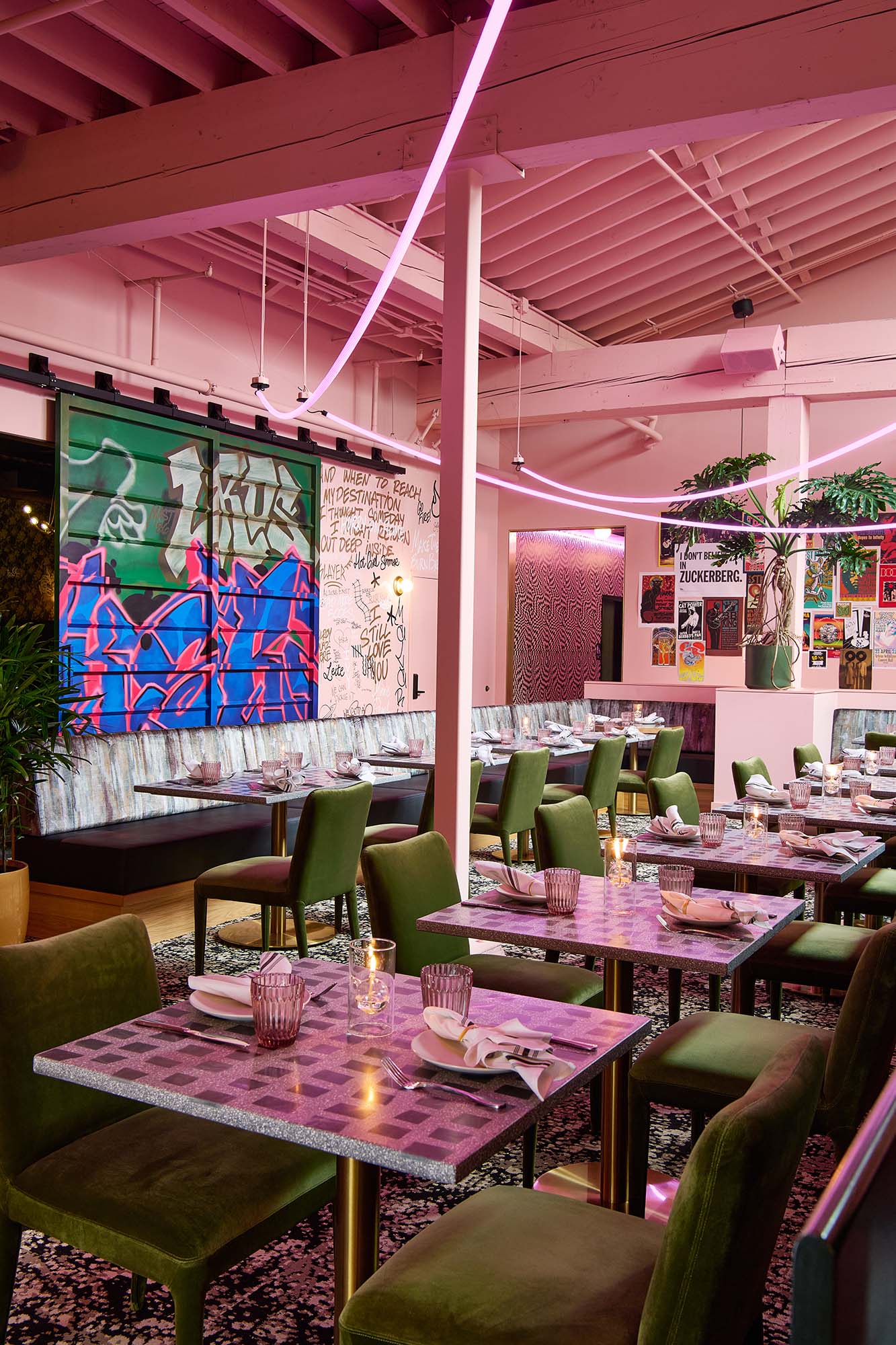 Graffiti Room at The Malarkey in Portland, designed by Tricorn Black, featuring custom graffiti doors, pink neon lighting, green dining chairs and layered wall art.