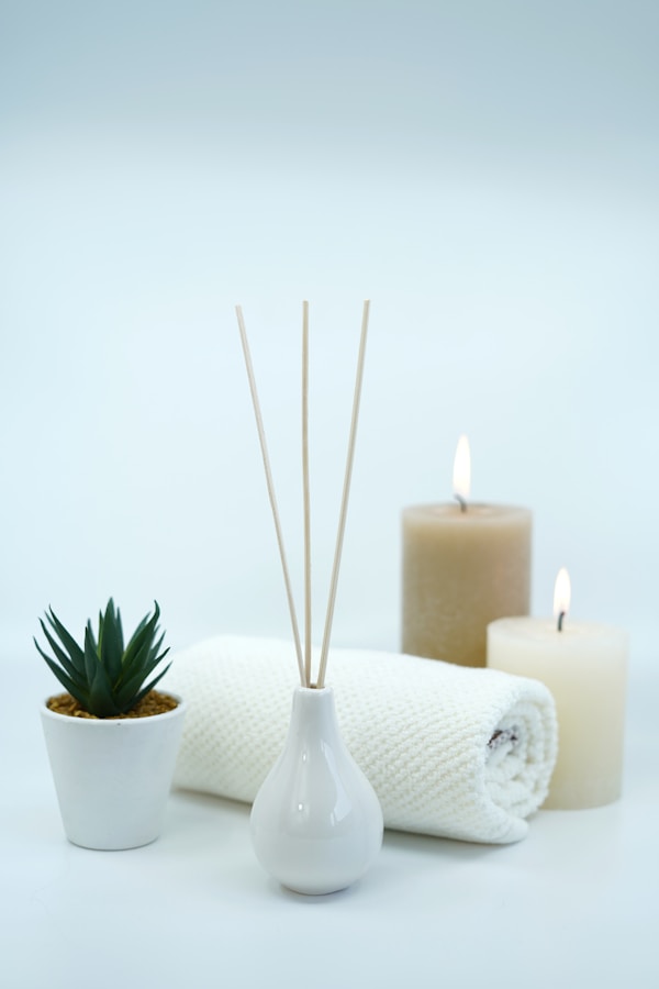 Beautiful image with spa and relaxing concept with scented oil fragrance diffuser and candles and towel