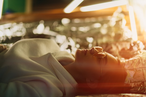 person in white long sleeve shirt lying on bed
