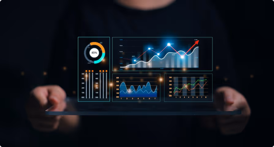Person holding a tablet displaying futuristic holographic data charts and graphs with glowing blue highlights on a dark background.
