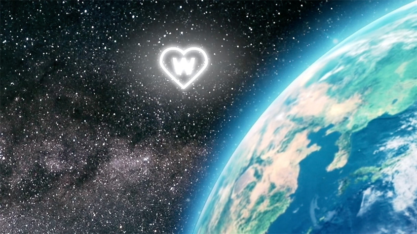 View of Earth from space with a glowing heart shape containing the letter W among the stars in the background.