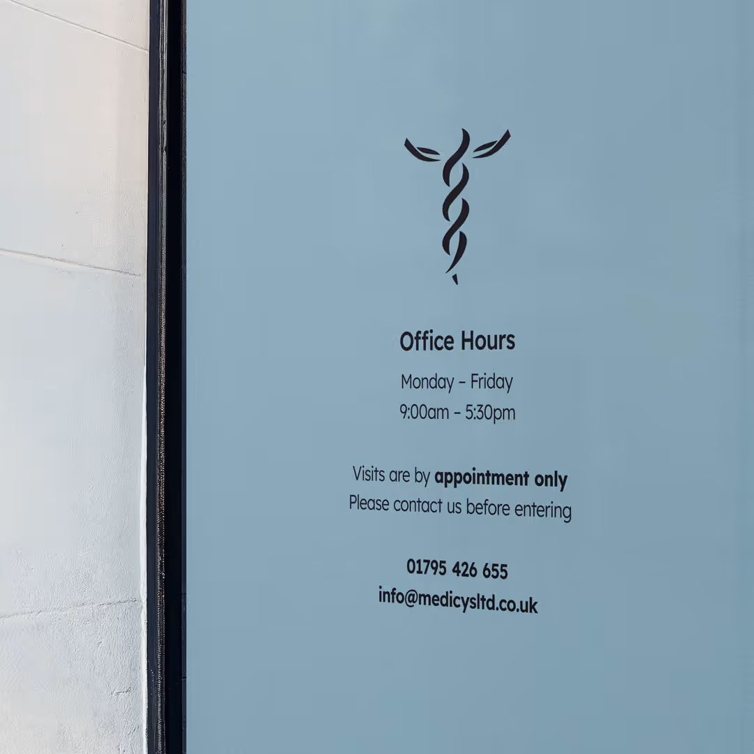 Office window displaying office hours Monday to Friday 9:00am to 5:30pm, visits by appointment only, and contact details with phone number and email.