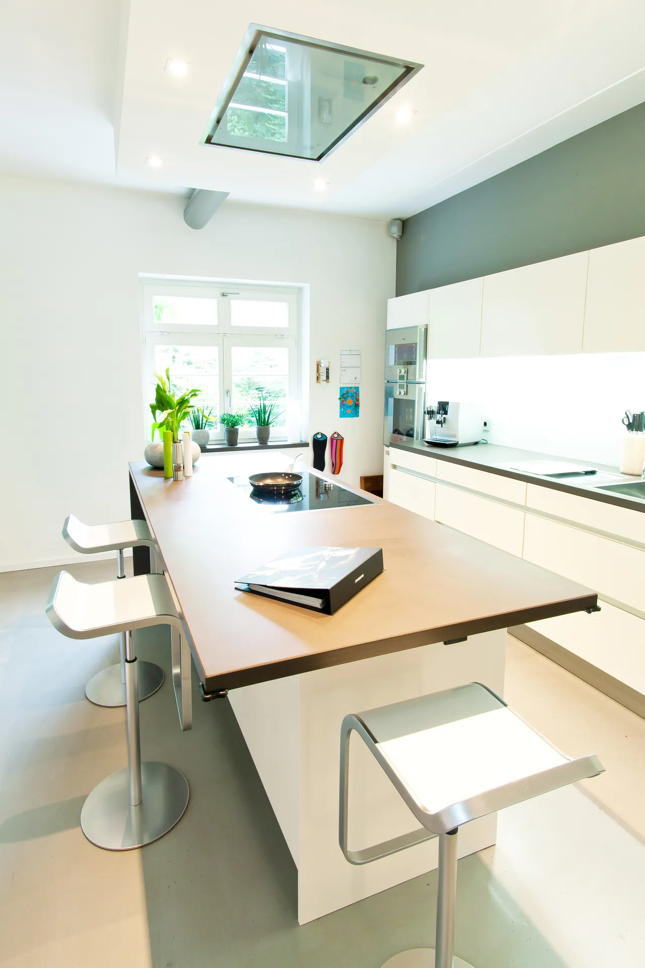 Grifflose Designküche – Weiße Küche mit Grauwacke und Gaggenau Geräten