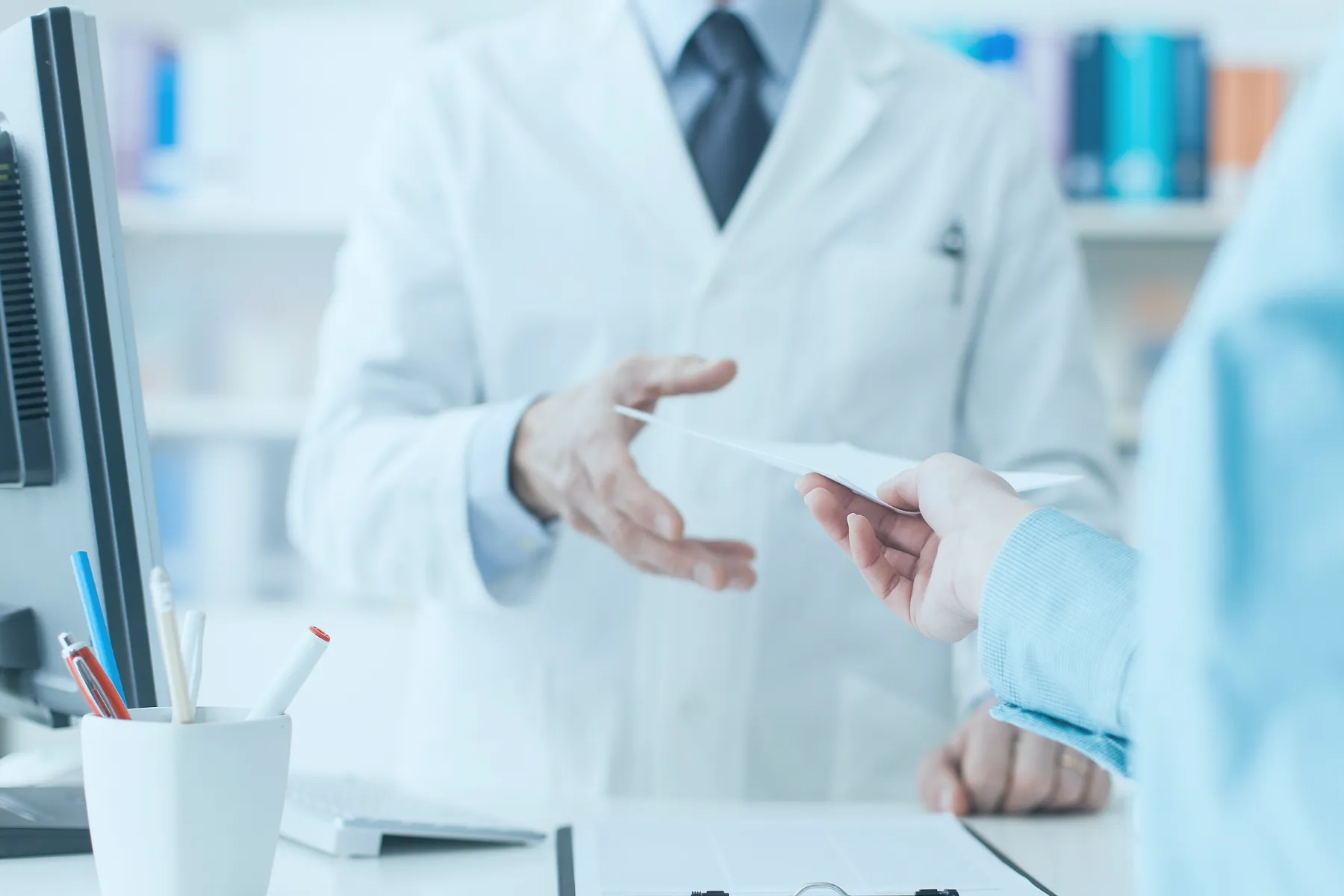 Pharmacy operator receiving prescription from patient