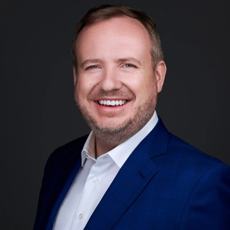 A portrait of a middle-aged smiling man. 