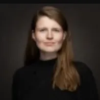 A portrait of a young woman on a dark background.