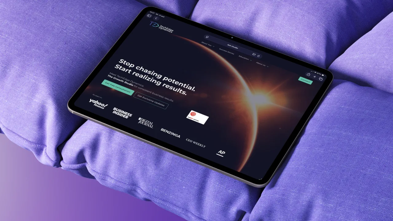 An iPad on a purple cushion.