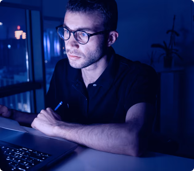 Penetration tester working on laptop