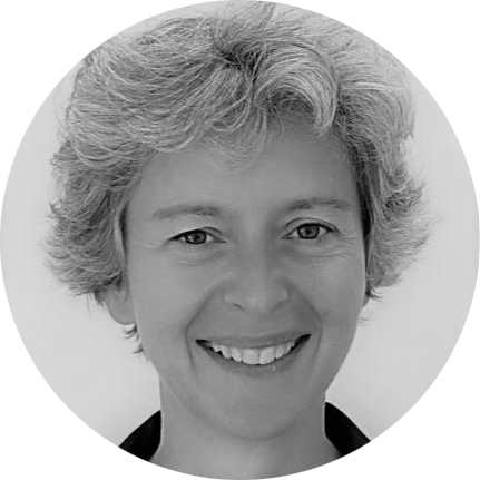 Black and white close-up portrait of a smiling woman with short curly hair.