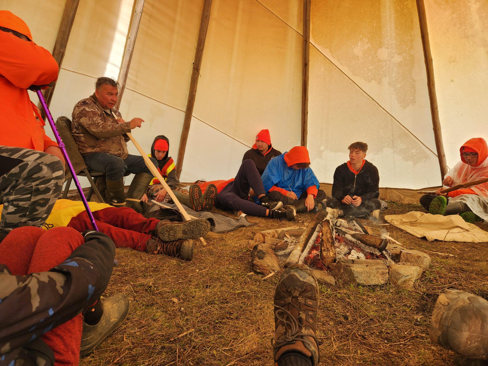 Photo of youth participating in activities in a Wigwam in Eskasoni First Nation.