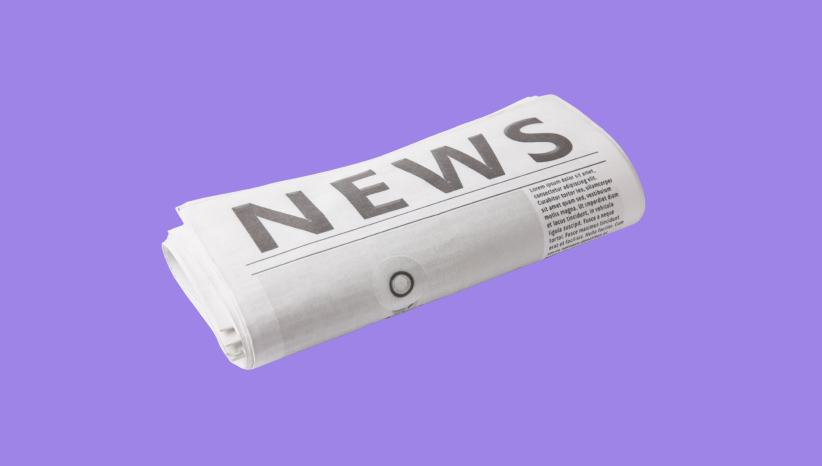 Folded newspaper with bold headline reading 'NEWS' on a purple background.