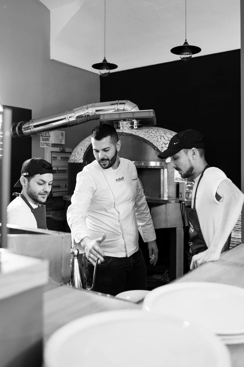 Thin pizza coming out from the oven