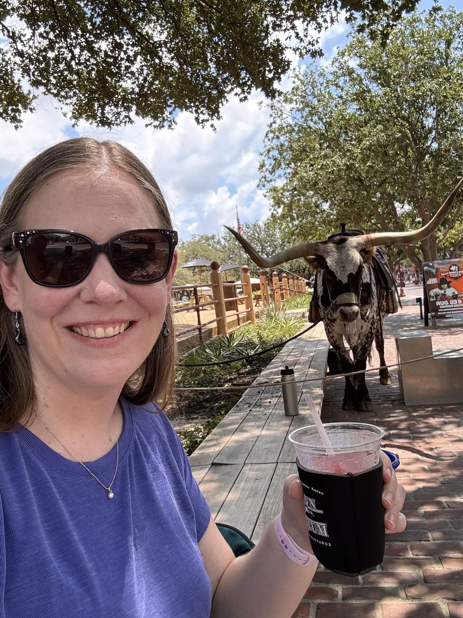 Woman taking selfie with a drink