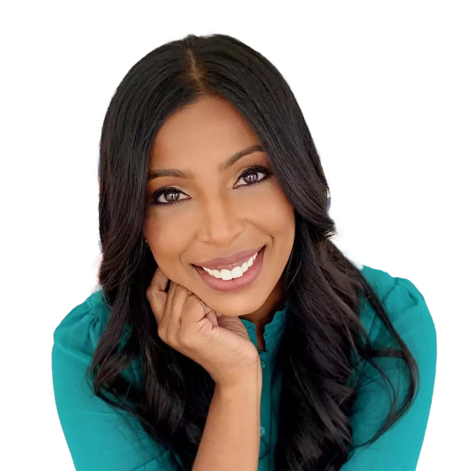 Smiling woman with long dark hair resting her chin on her hand, wearing a teal top.