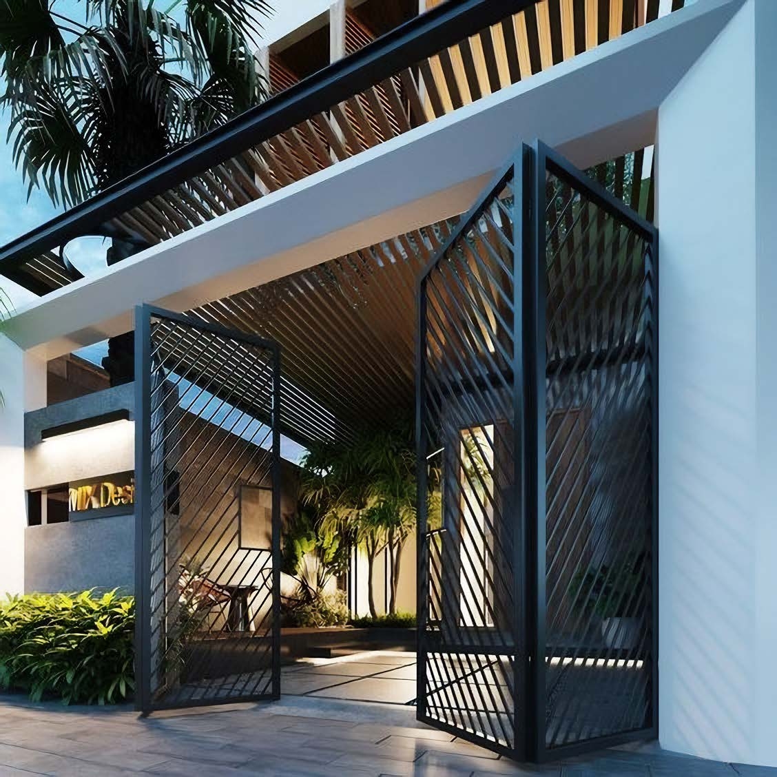 Entrada moderna con puertas metálicas negras y plantas decorativas en interior iluminado.