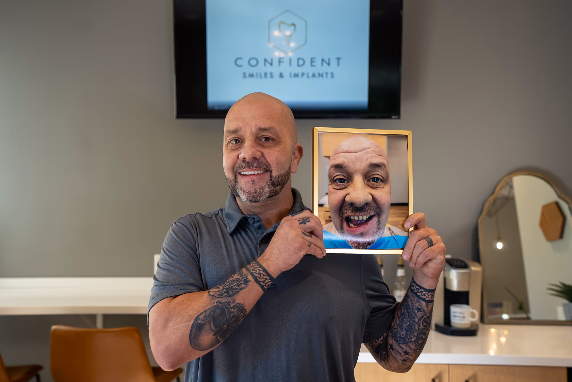 A man holding up a picture of a man's face.