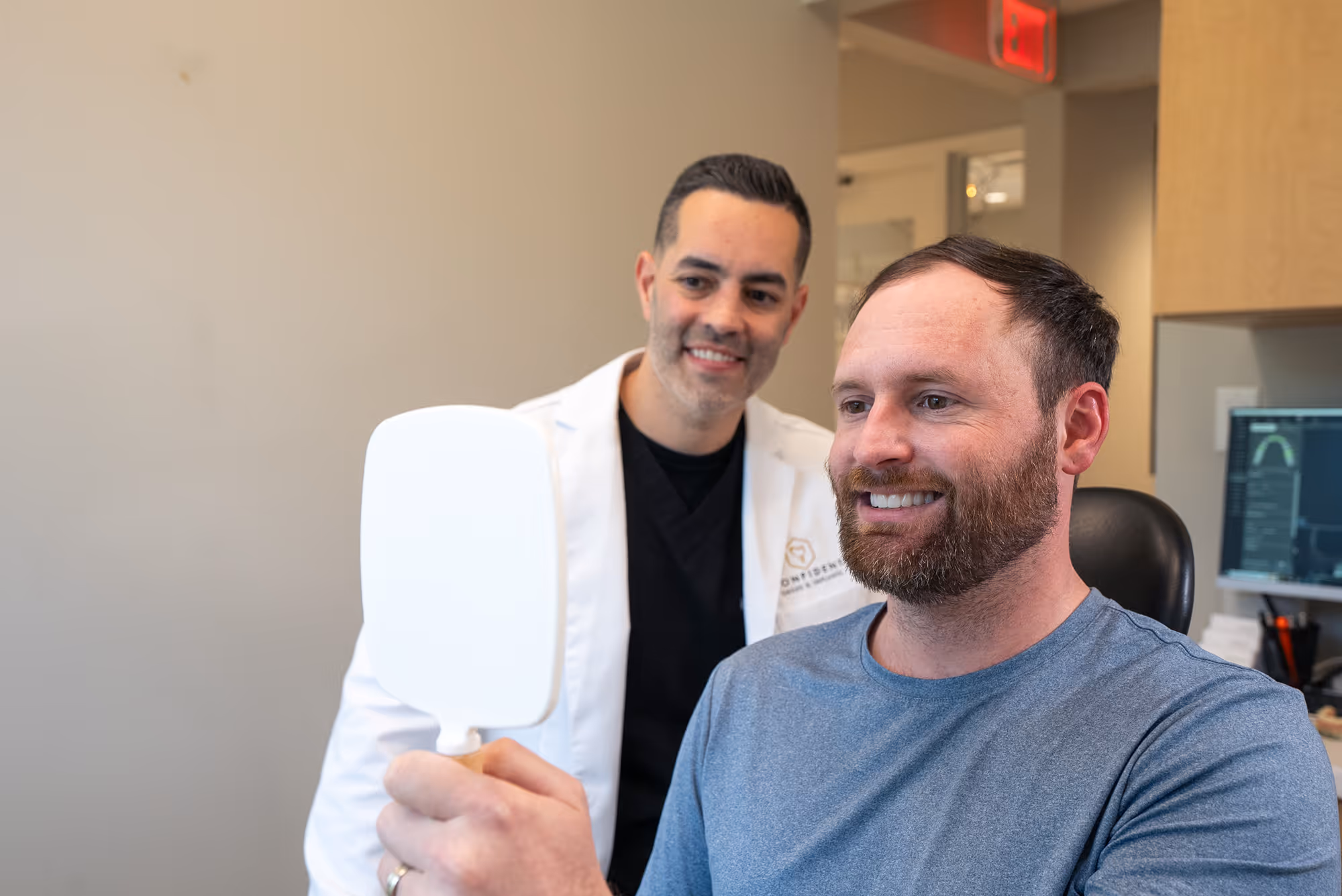 A man in a white lab coat holding a white object.