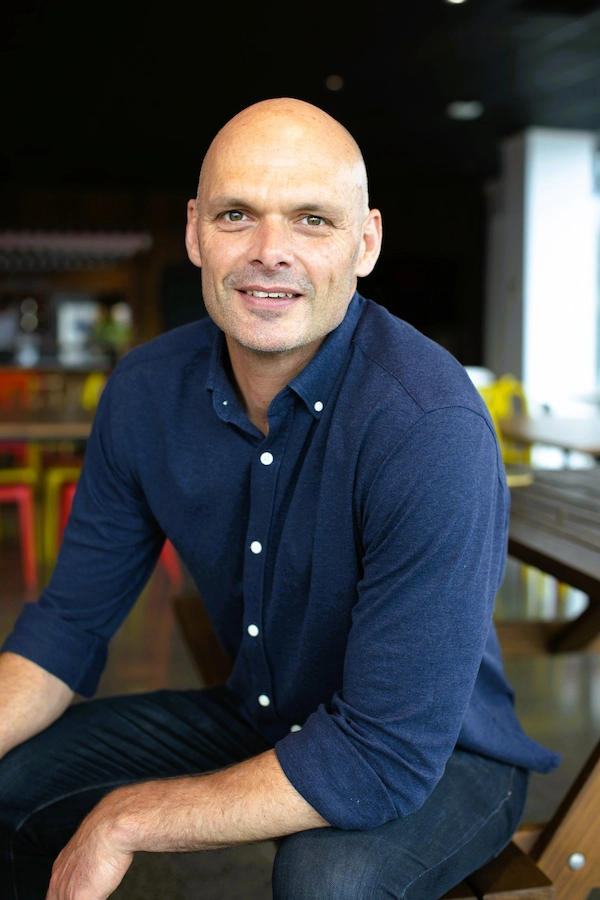 A picture of Charles Capamagian in smart form business wear in a relaxed pose