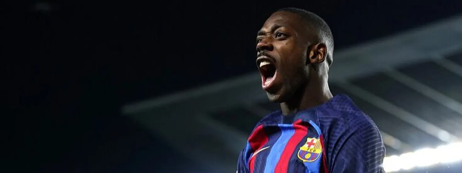 FC Barcelona player passionately celebrating during a night match.