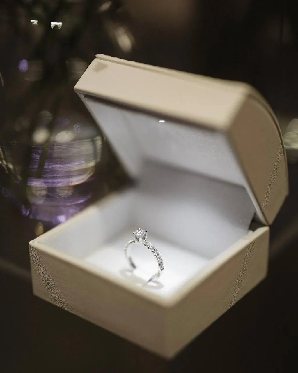 Diamond solitaire engagement ring with pavé band displayed in an ivory velvet box at a luxury proposal event planned by Perla Signature Events in Yerevan, Armenia