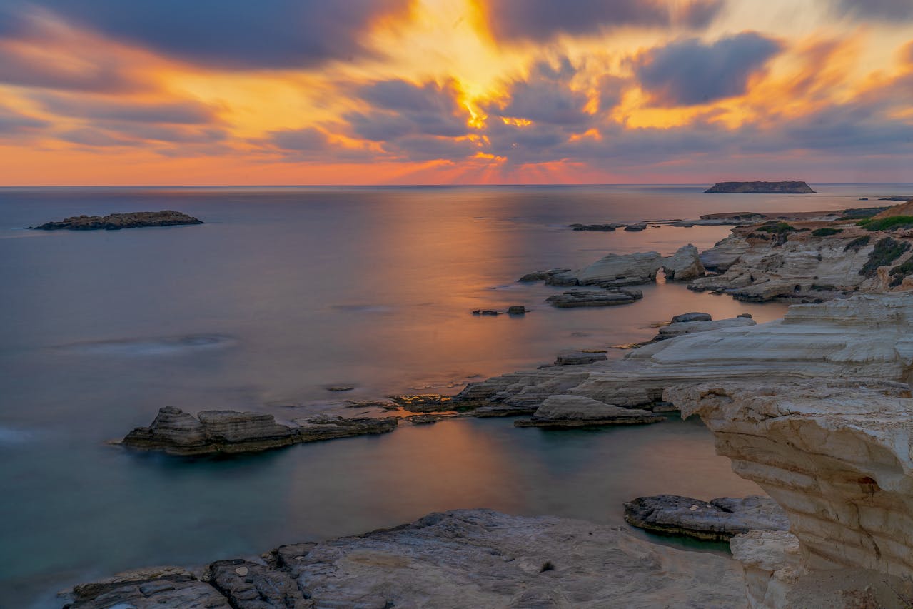 Turquoise bay in Menorca at sunset with calm water and rocky coastline