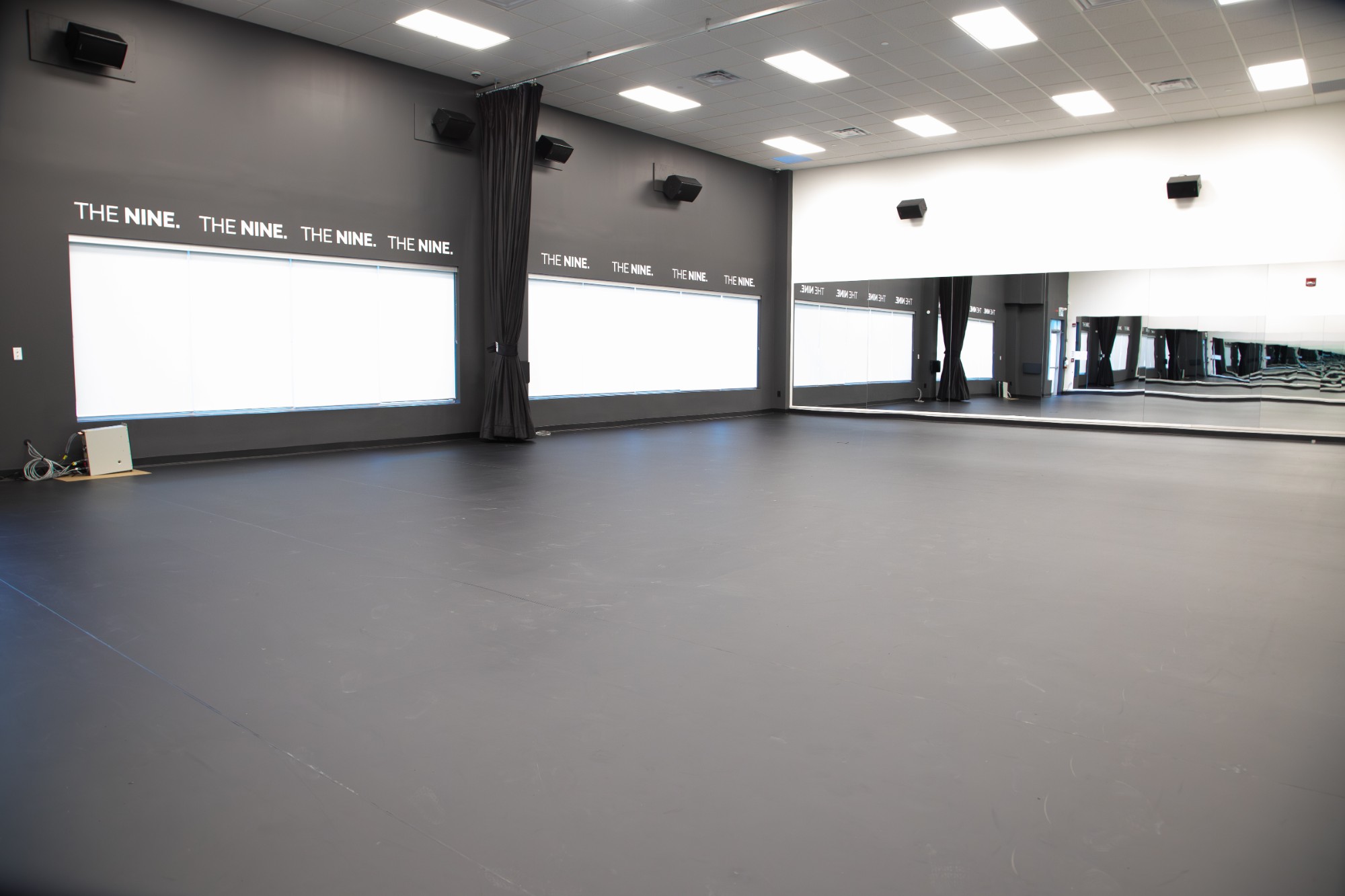 Spacious dance studio with marley floor and mirrors at The NINE Dance Academy
