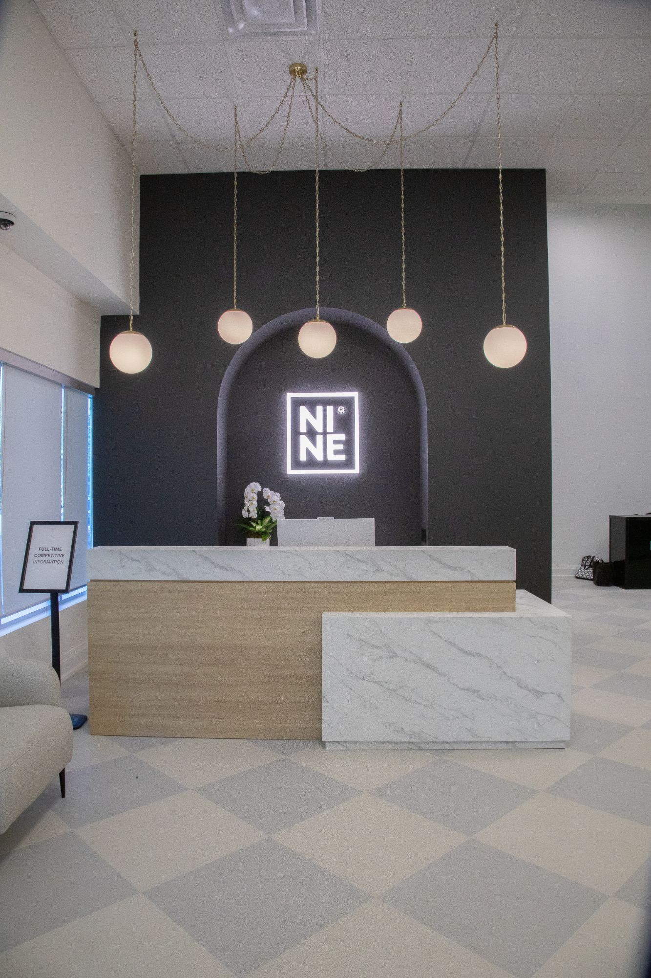 The NINE Dance Academy reception desk and glowing NINE logo in the new Vaughan lobby