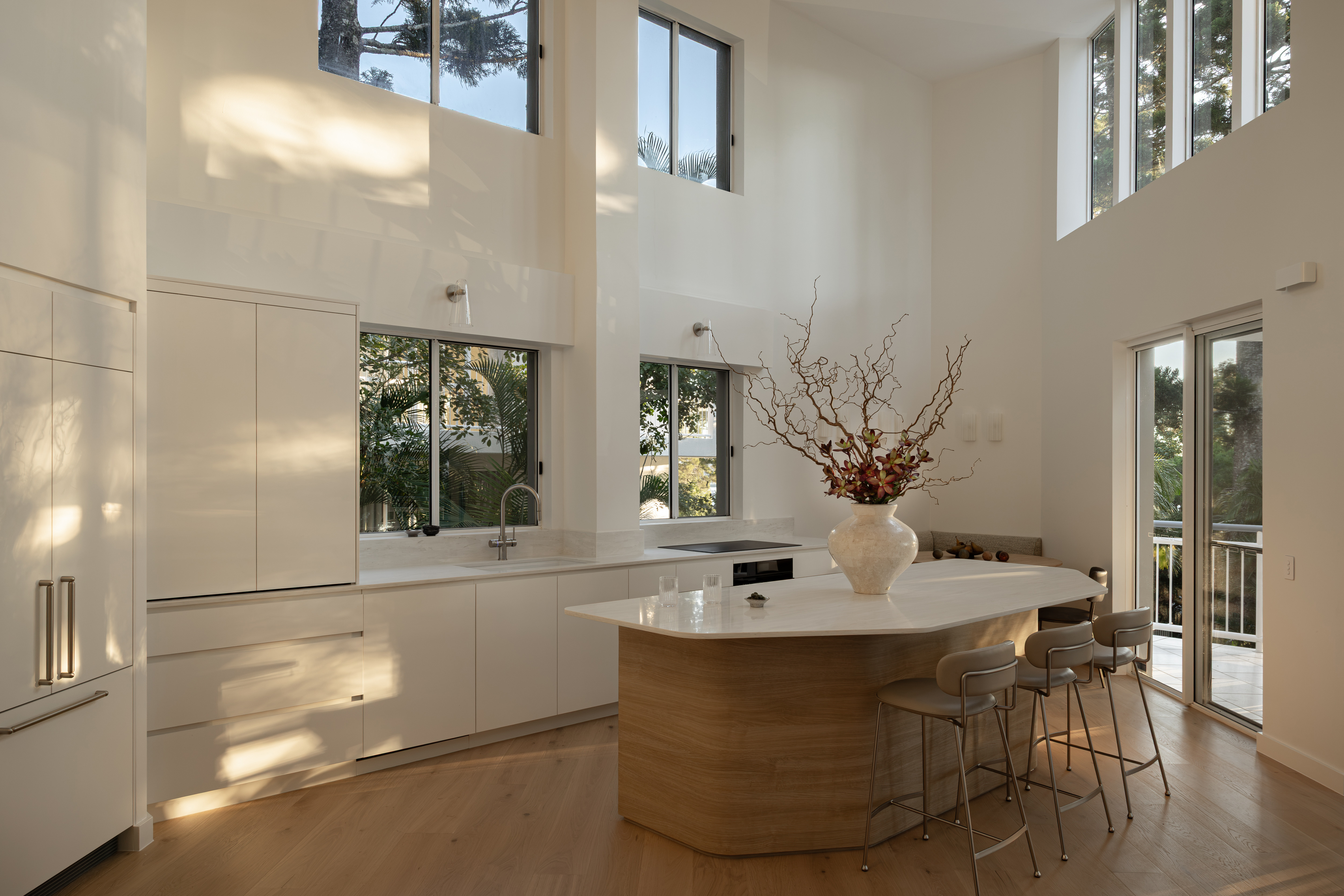 Open-plan kitchen with double-height windows, Edgar Bennett home renovation in Noosa Heads by Pearl Interiors
