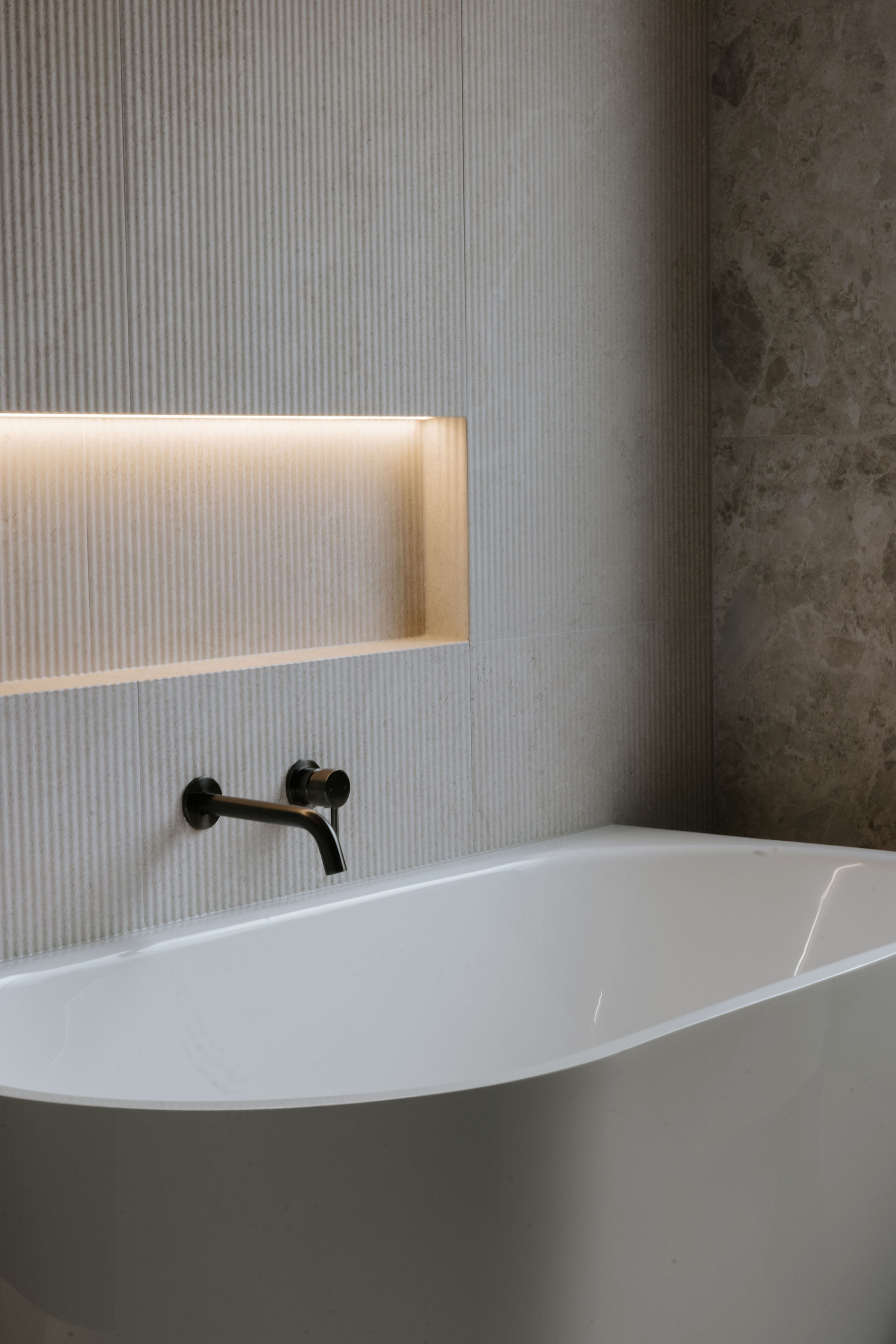 Freestanding bath and tiled feature wall in a Sunshine Coast bathroom designed by Pearl Interiors