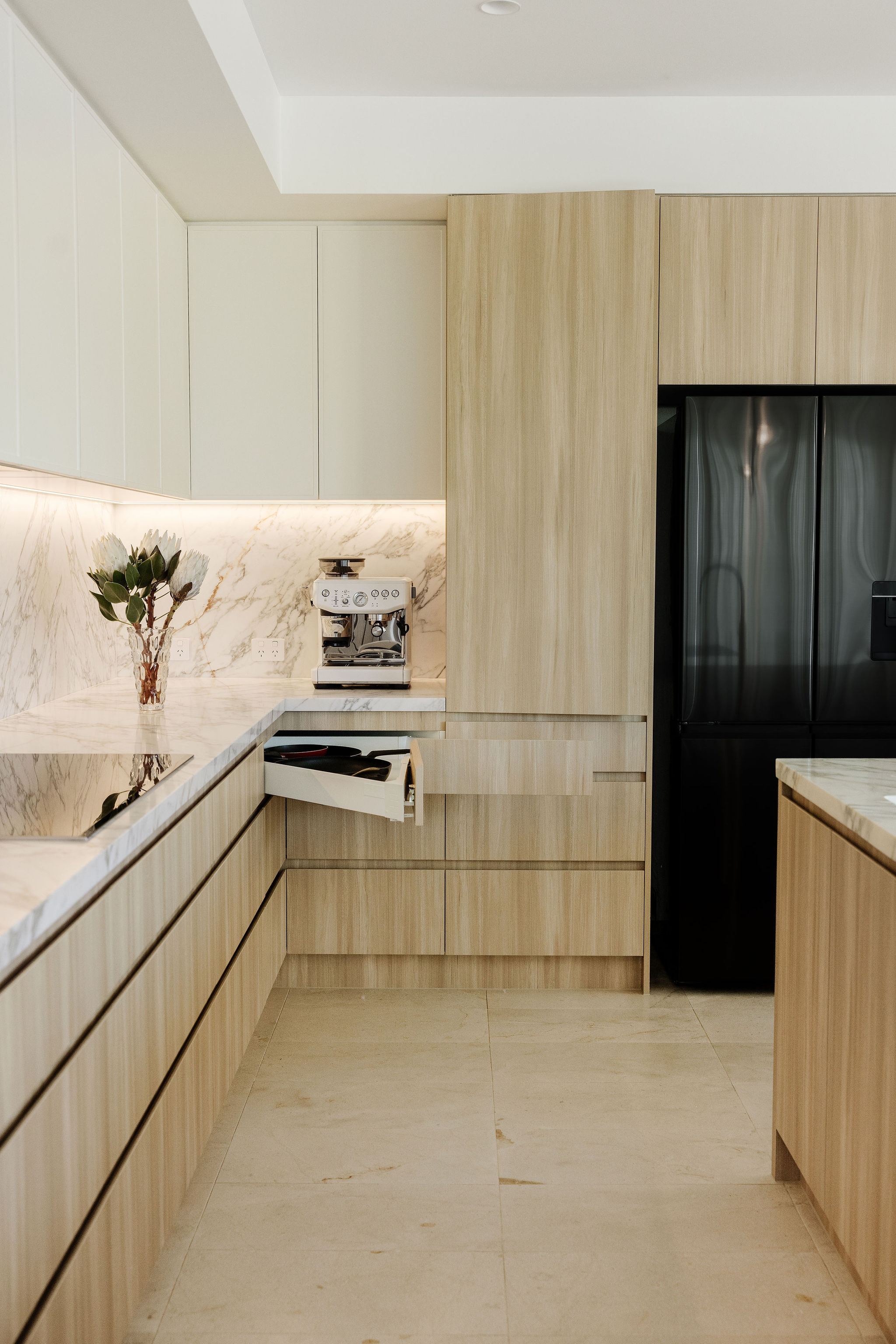 Integrated appliances and cabinetry, kitchen, laundry and powder room renovation on Orient Drive, Sunrise Beach by Pearl Interiors, built with Nomad Builders, Franca Designs stone benchtops and Faucet Strommen tapware, Sunshine Coast