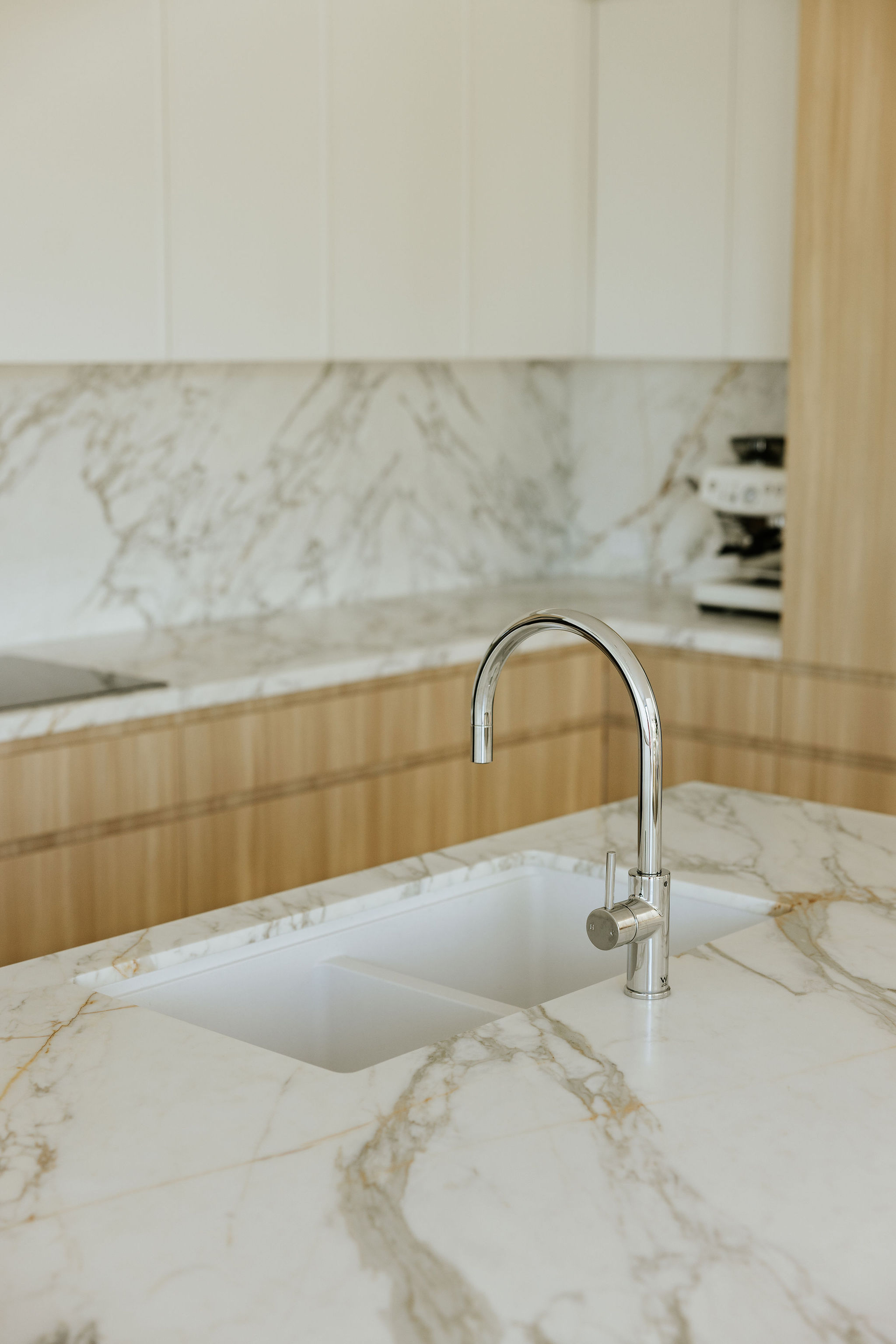 Open kitchen and dining space, kitchen, laundry and powder room renovation on Orient Drive, Sunrise Beach by Pearl Interiors, built with Nomad Builders, Franca Designs stone benchtops and Faucet Strommen tapware, Sunshine Coast