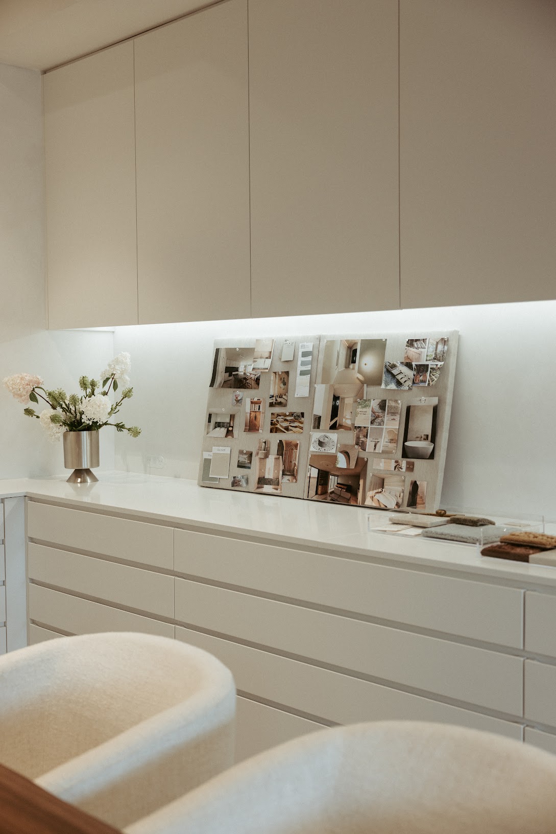 Curated furniture vignette, Pearl Interiors flagship design studio in Noosa Heads, Sunshine Coast, natural stone, timber joinery and vintage lighting
