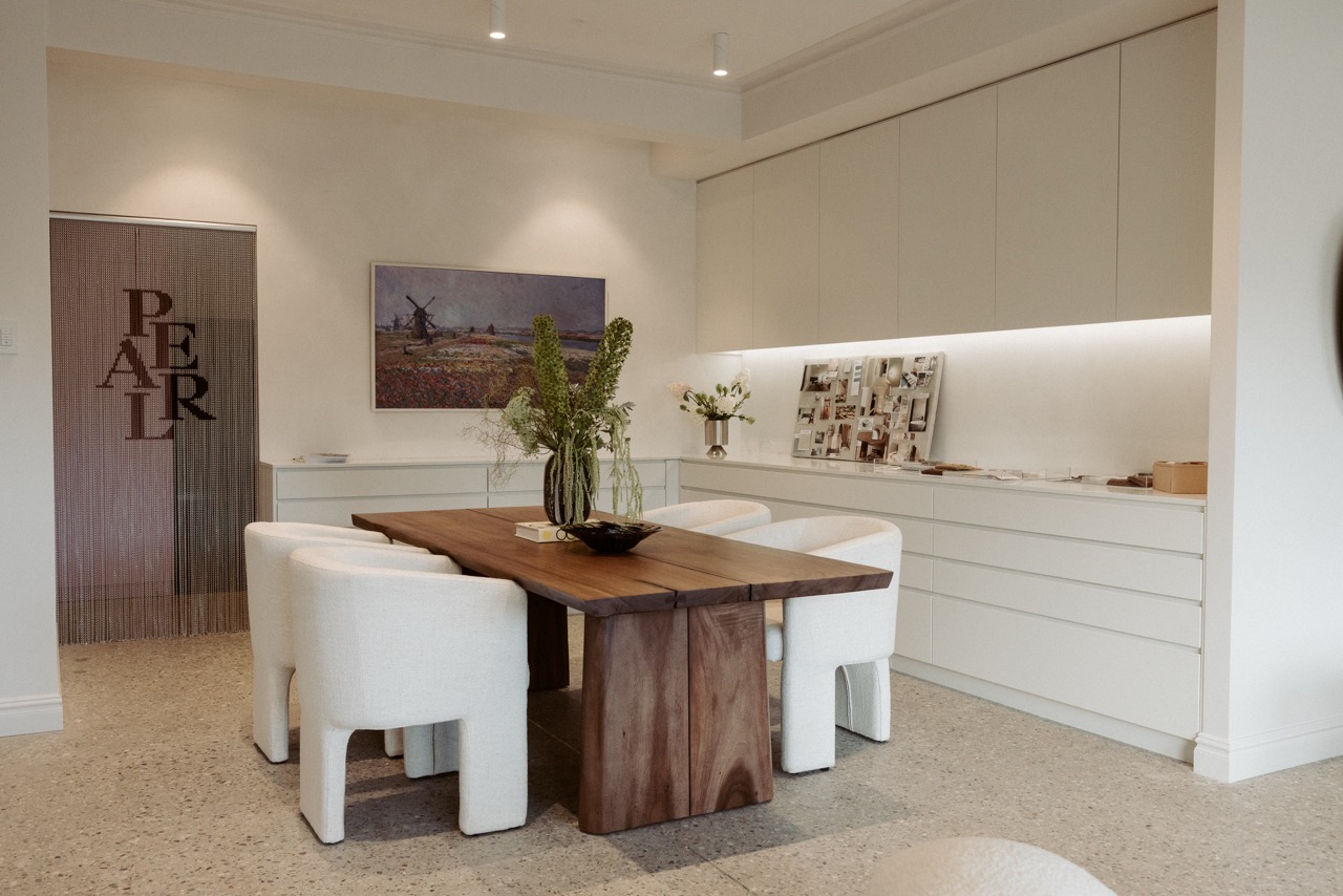 Reception and greeting area, Pearl Interiors flagship design studio in Noosa Heads, Sunshine Coast, natural stone, timber joinery and vintage lighting