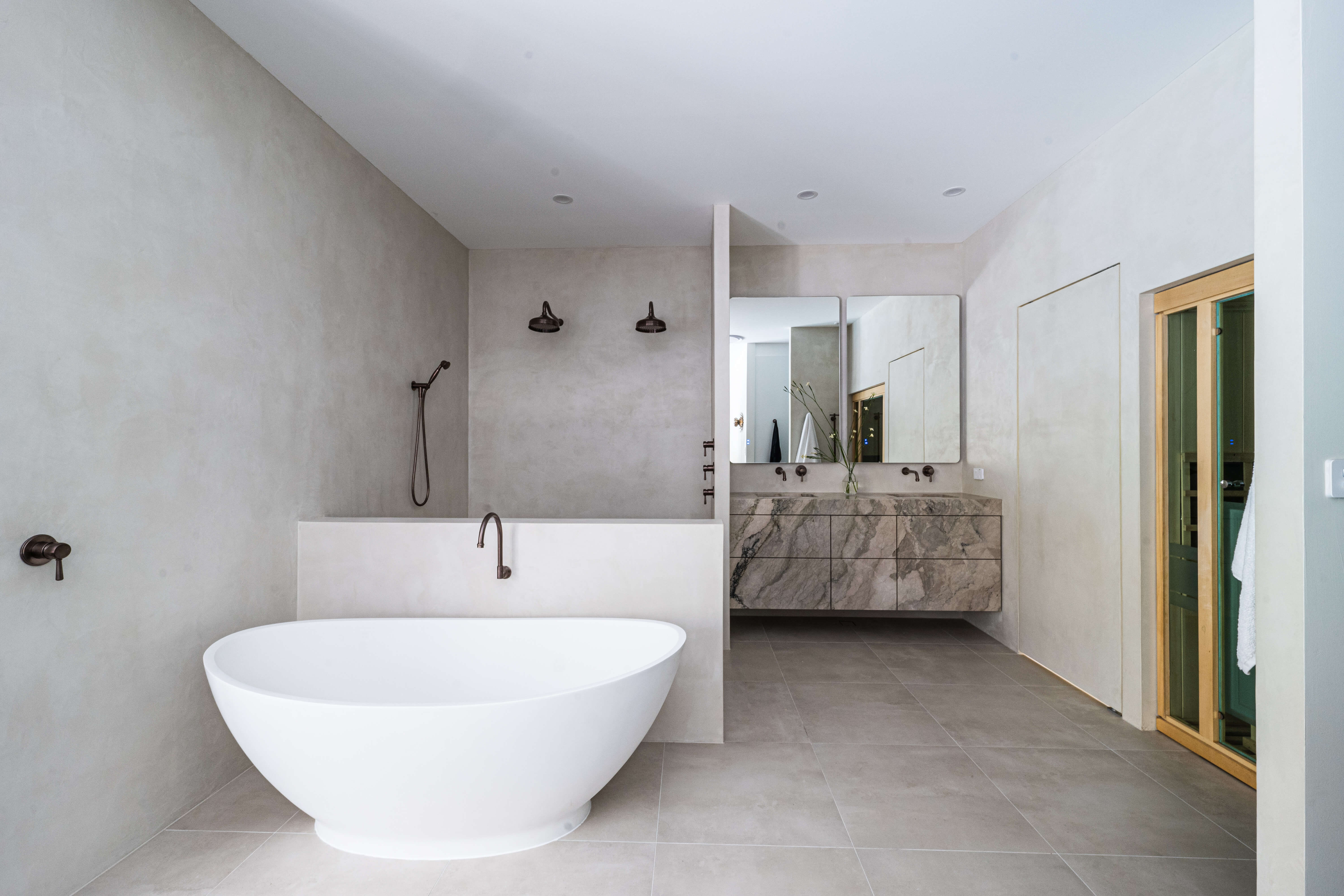 Soft ambient lighting, moody spa-inspired parents' bathroom renovation in Timbeerwah, Noosa Hinterland by Pearl Interiors, built with Squire Development Group, Ace Stone and Tile stone tiling and Faucet Strommen tapware