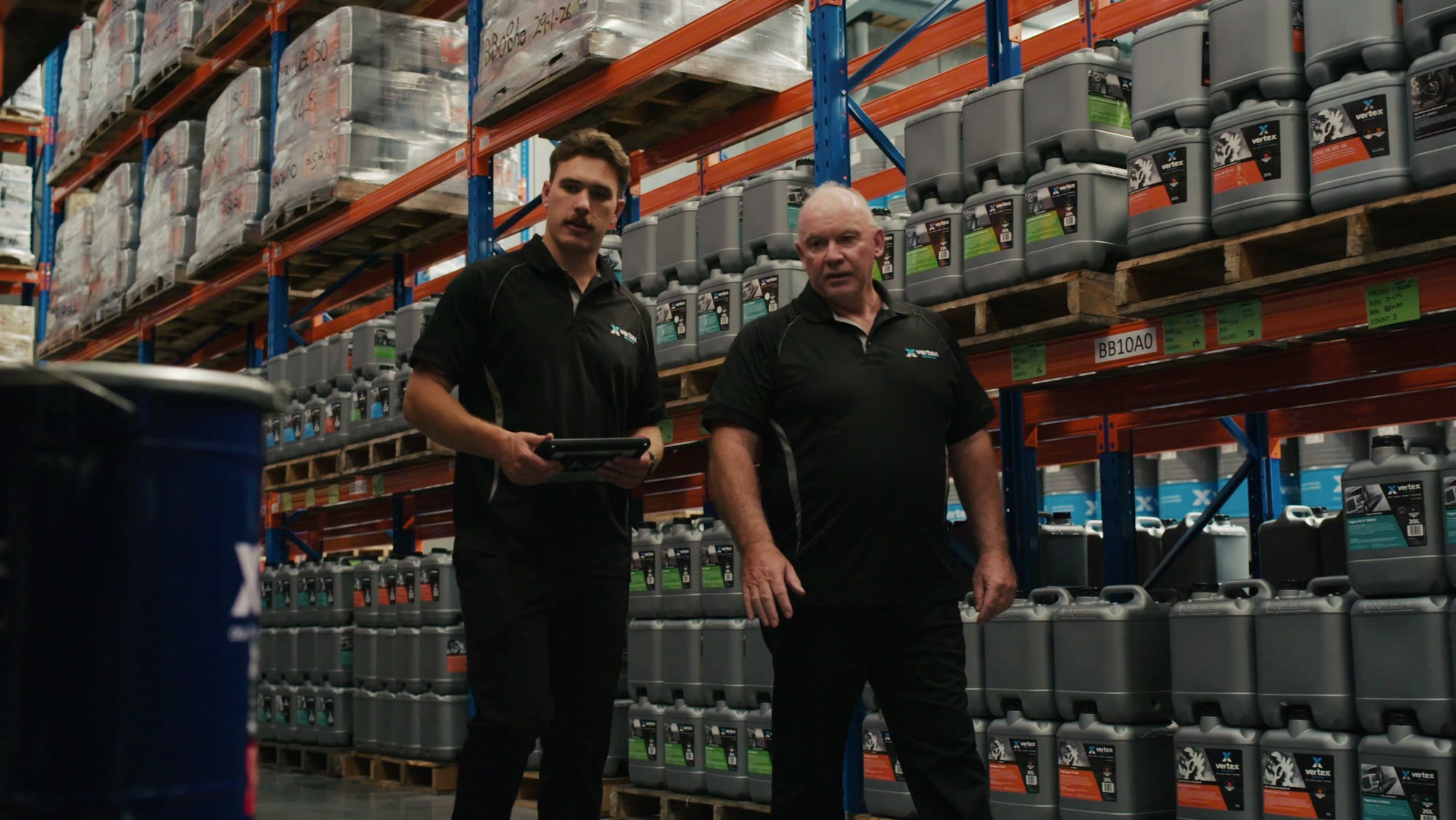 Two Vertex Lubricants team members in their warehouse, from brand content filmed by Refined