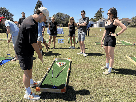 group of friends playing mini golf at Putt Party
