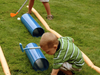 Child playing mini golf