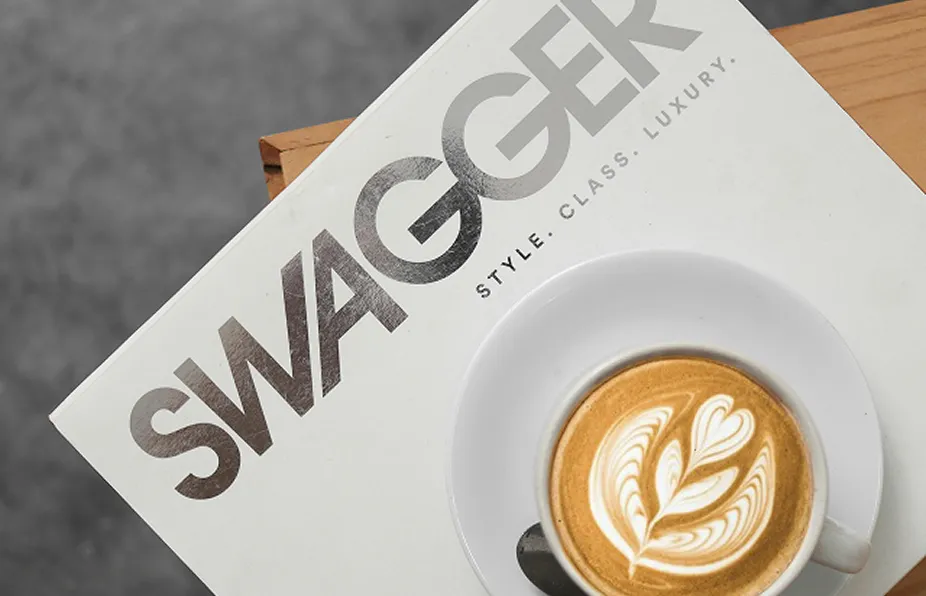 Velt magazine with a cup of coffee on top of it