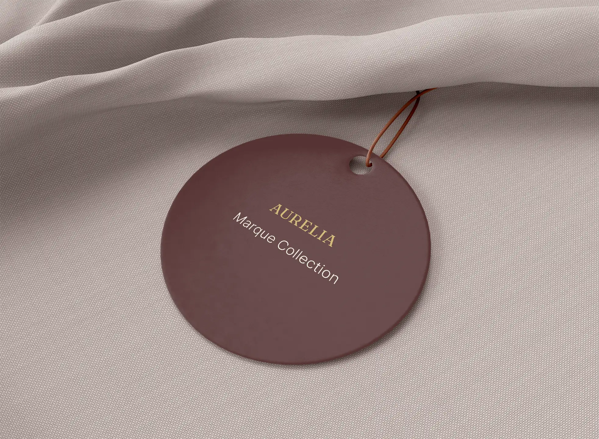 Aurelia burgundy garment tag with gold typography.