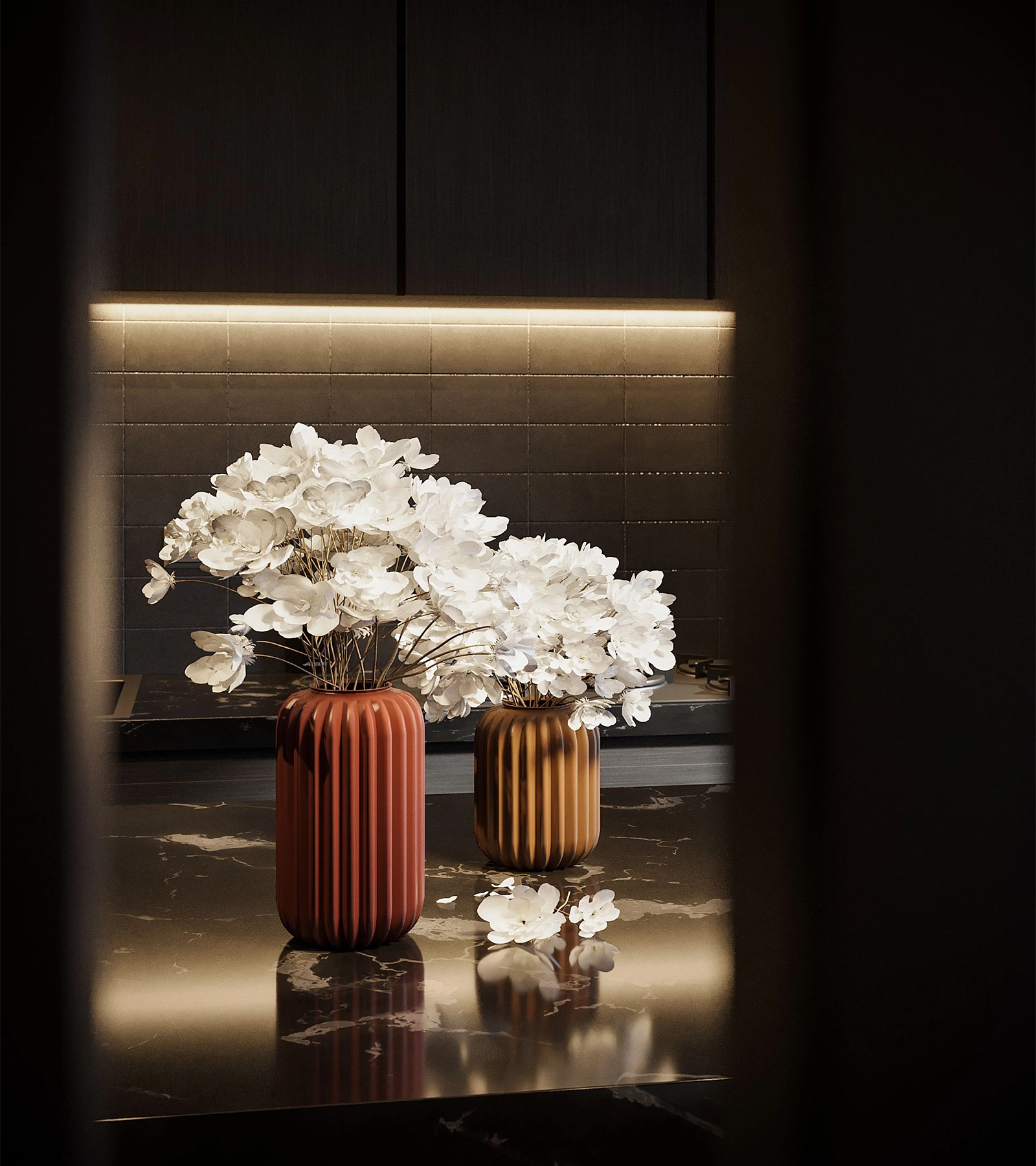 White flowers in two decorative vases on a polished stone counter