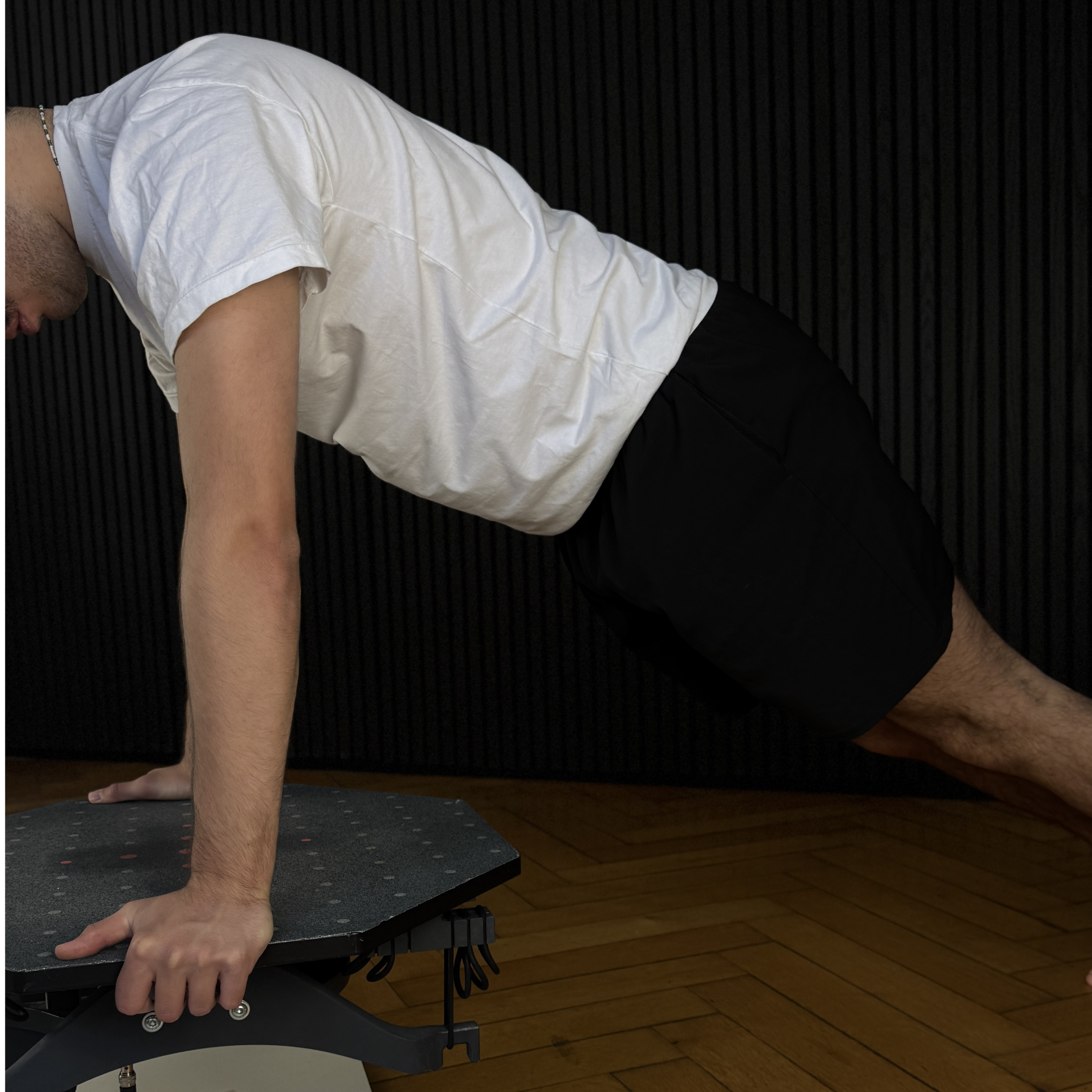 Eine Person in der Liegestützposition auf dem neurotrim Gerät.