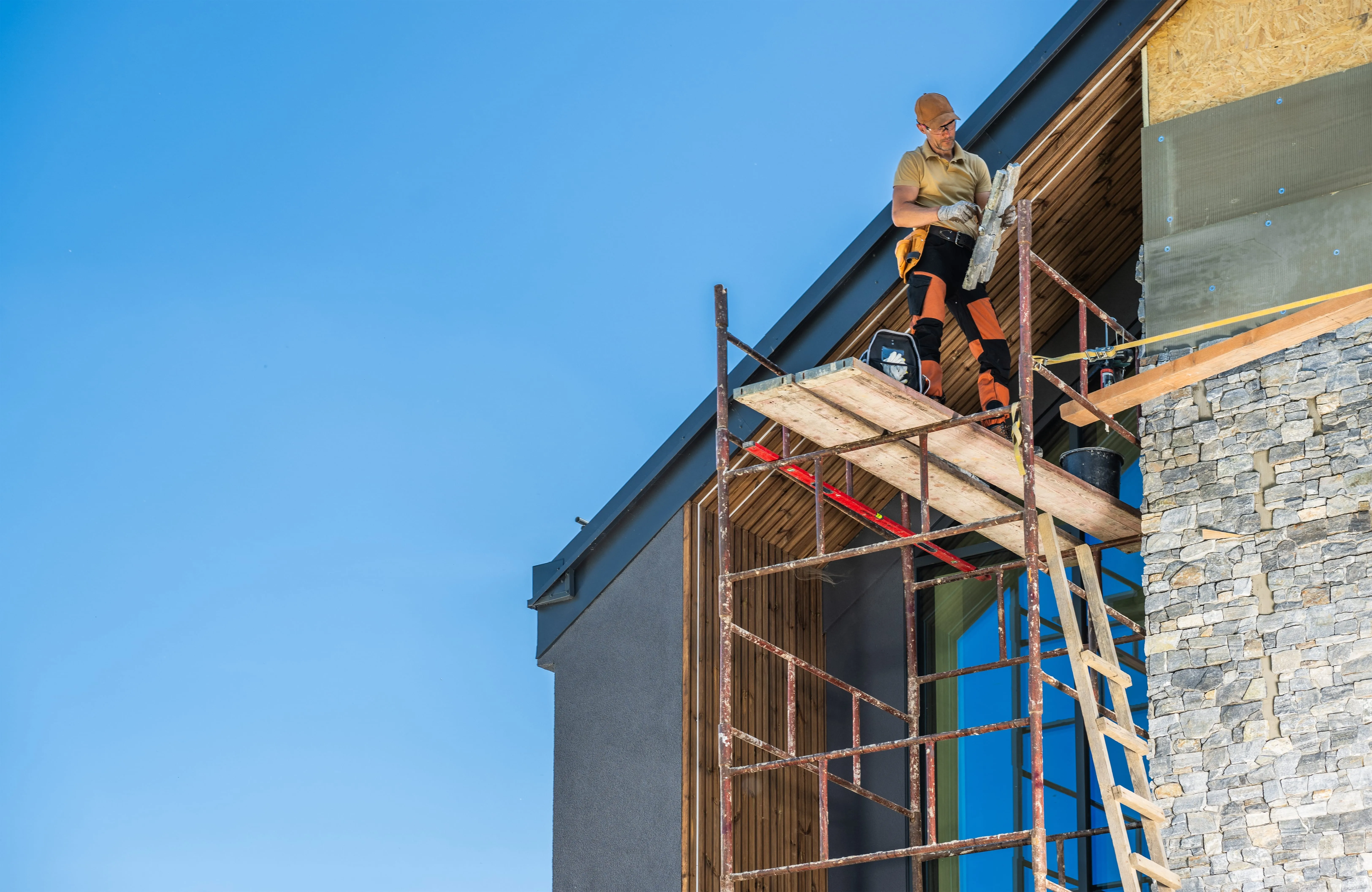 Technician performing chimney masonry repair on residential home in Novi
