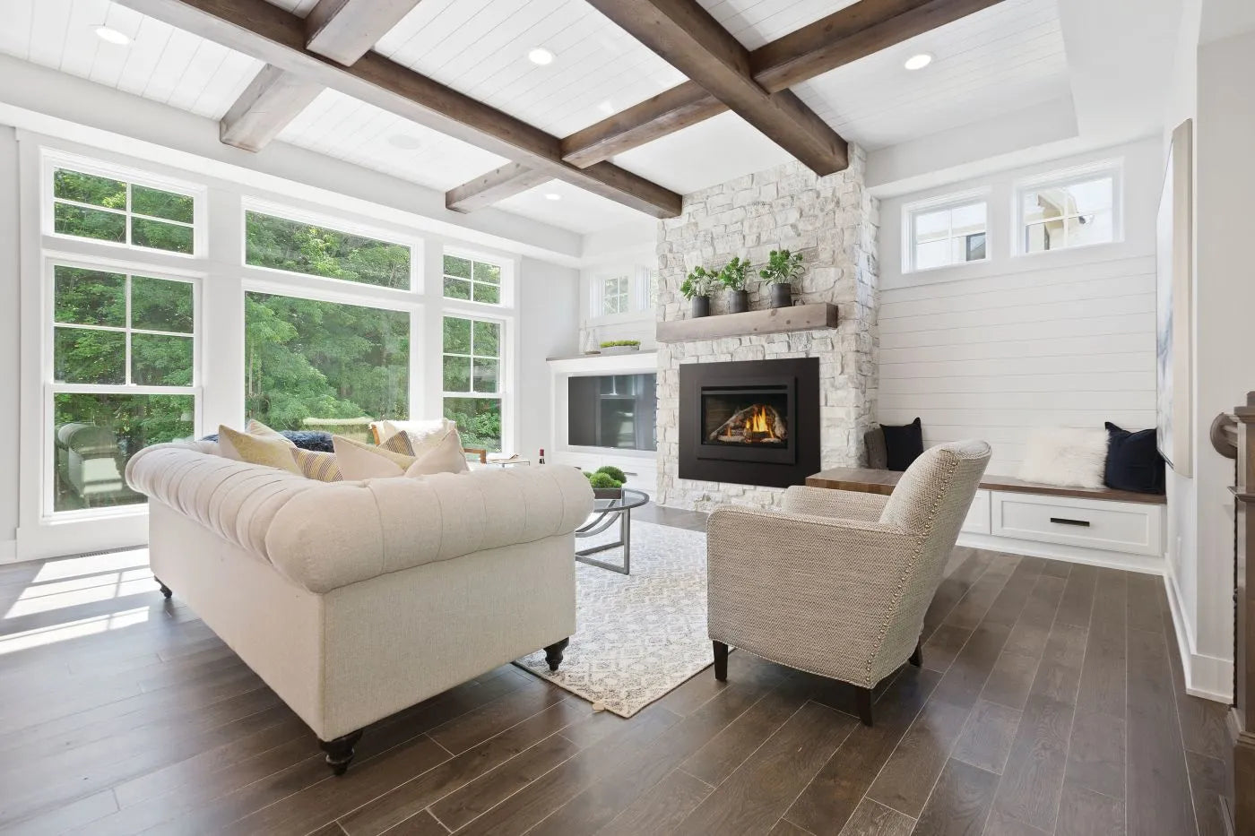 Gas fireplace insert with birch log set burning in an existing fireplace