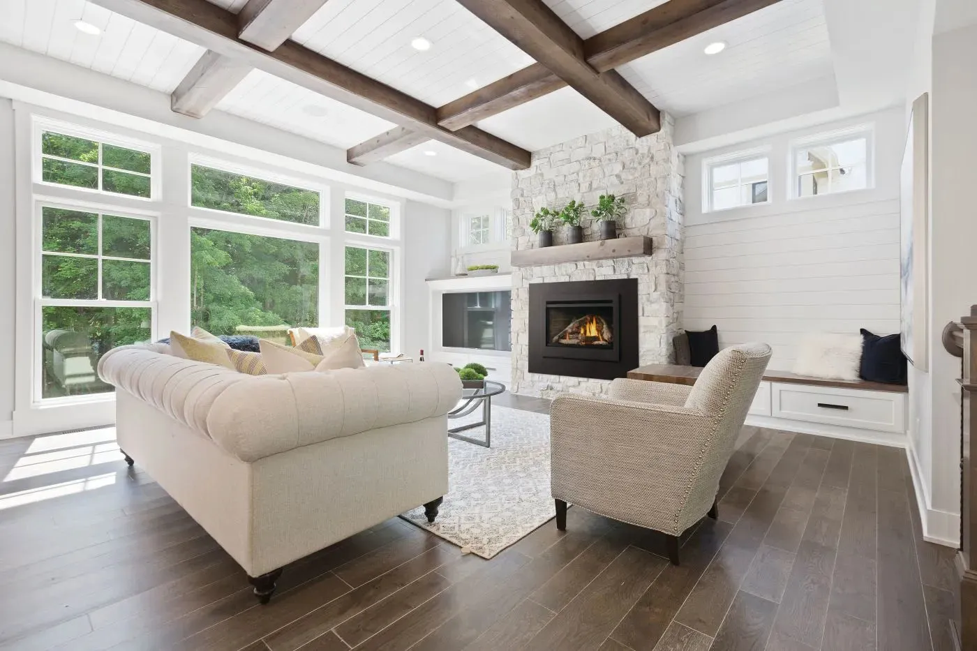 Gas fireplace insert with birch log set burning in an existing fireplace