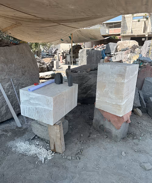 Raw onyx and stone blocks at the workshop where Liana Yaroslavsky sources and carves materials for LIKA Atelier collectible furniture and lighting